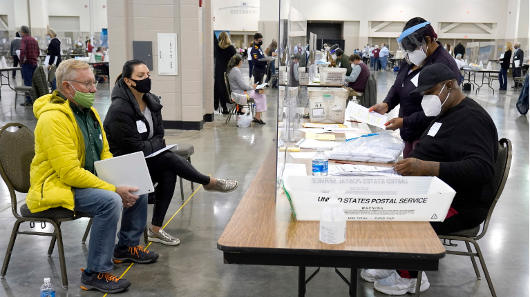 Election workers verify ballots as recount observers watch during a Milwaukee hand recount of presidential votes at the Wisconsin Center. The recount of the election in Wisconsin’s two most heavily Democratic counties began Fwith President Donald Trump’s campaign seeking to discard tens of thousands of absentee ballots that it alleged should not have been counted. (AP Photo/Nam Y. Huh)