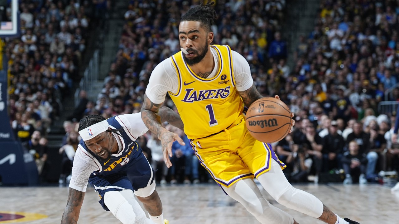 Los Angeles Lakers guard D'Angelo Russell (1) drives past Denver Nuggets guard Kentavious Caldwell-Pope in the second half of Game 5 of an NBA basketball first-round playoff series Monday, April 29, 2024, in Denver. (AP Photo/David Zalubowski)